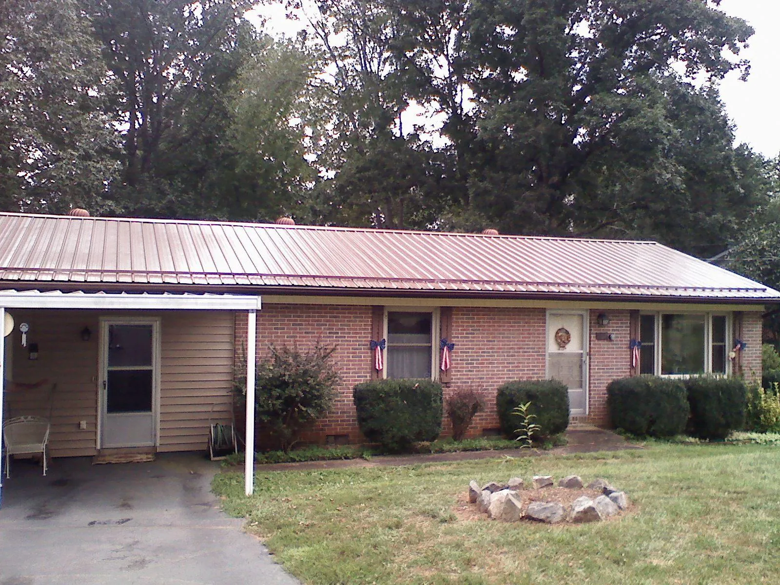 Bronze metal roof and carport on a brick ranch home — Roof Repair work by our crew in West Harwich